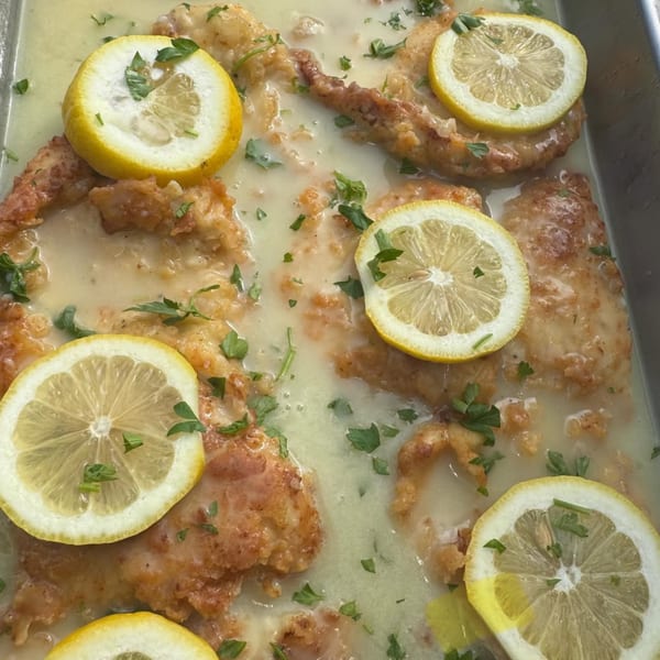 Chicken piccata with lemon slices and parsley in a creamy sauce, from Emma's Deli.